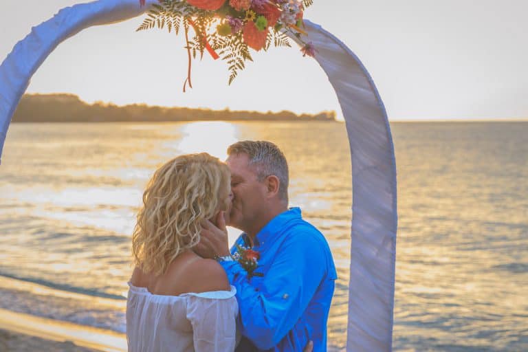 Newly Weds Kissing under arch